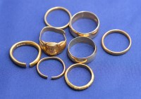 Lot 180 - Two 22ct. yellow gold wedding bands both cut;...