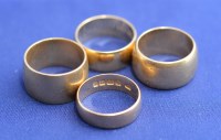 Lot 182 - Four broad 18ct. yellow gold wedding bands,...