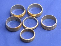 Lot 187 - Six 18ct. yellow gold broad wedding bands, one...