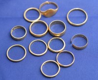 Lot 194 - Nine 18ct. yellow gold wedding bands, one cut;...