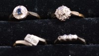 Lot 224 - A diamond cluster ring, a two-stone cross over...