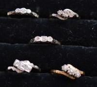 Lot 228 - Five three-stone diamond rings in illusion...