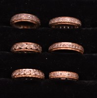 Lot 242 - Six white stone-set eternity rings in yellow...