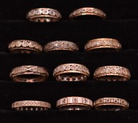 Lot 244 - Eleven white stone-set eternity rings, mounted...