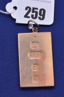 Lot 259 - A 9ct. gold ingot pendant, 34.1grms.