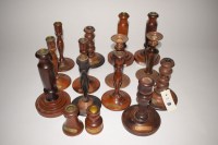 Lot 150 - Fifteen turned wooden candlesticks, mainly...