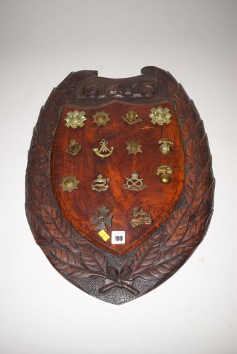 Lot 199 - A WWI carved oak shields inscribed '1914-15'...