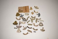 Lot 211 - A large quantity of pierced brass cap badges...