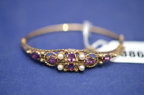 Lot 386 - A Victorian style bangle set with pink stones,...