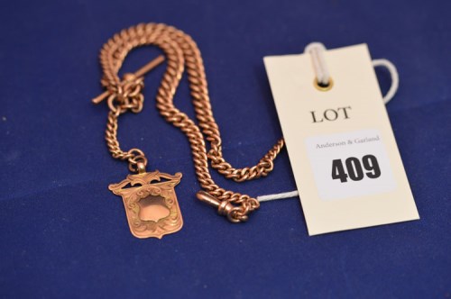 Lot 409 - A 9ct. rose gold Albert chain and fob,...