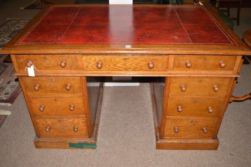 Lot 628 - An early 20th Century oak pedestal desk, inset...