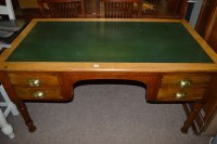 Lot 684 - An early 20th Century oak desk, fitted green...
