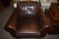 Lot 695 - A brown leather covered armchair.
