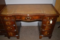 Lot 853 - A reproduction mahogany kneehole desk with...