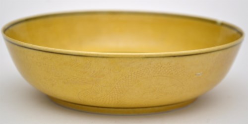 Lot 504 - Chinese yellow glaze 'Dragon' bowl, the...