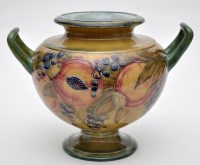 Lot 599 - Moorcroft 'Pomegranate on Ochre' twin handled...