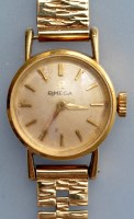 Lot 809 - Omega: a lady's 18K gold cased wristwatch,...