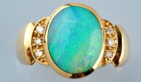 Lot 847 - An opal and diamond ring, the oval opal...