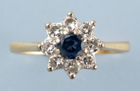 Lot 849 - A sapphire and diamond cluster ring, the...