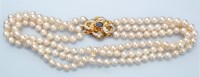 Lot 850 - A cultured pearl triple row necklace, the...