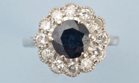 Lot 859 - A sapphire and diamond cluster ring, the...