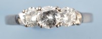 Lot 860 - A three stone diamond ring, the brilliant cut...