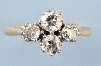 Lot 861 - A four stone diamond ring, the graduated...