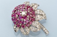 Lot 867 - A ruby and diamond flower pattern brooch, set...