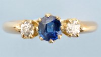 Lot 882 - A sapphire and diamond ring, the central...