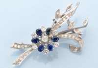 Lot 883 - A diamond and sapphire floral spray pattern...