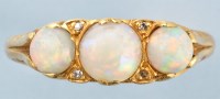 Lot 895 - An opal and diamond ring, the three graduated...