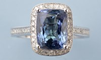 Lot 904 - A tanzanite and diamond cluster ring, the oval...