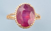 Lot 905 - A ruby and diamond cluster ring, the oval...