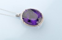 Lot 906 - An amethyst and diamond cluster pendant, the...