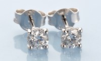 Lot 907 - A pair of diamond stud earrings, each...