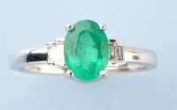 Lot 908 - An emerald and diamond ring, the oval facet...