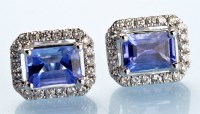 Lot 910 - A pair of tanzanite and diamond cluster stud...