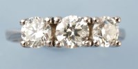 Lot 912 - A three stone diamond ring, the brilliant cut...