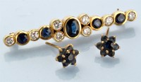 Lot 919 - A sapphire and diamond brooch, the central...