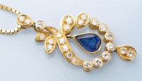 Lot 921 - A sapphire and diamond pendant, the central...