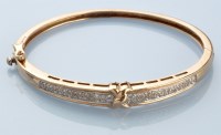 Lot 924 - A diamond set bangle, the front pave set with...