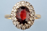 Lot 928 - A garnet and diamond cluster ring, the oval...