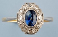 Lot 931 - A sapphire and diamond ring, the oval facet...