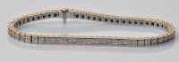 Lot 939 - A diamond line bracelet, the baguette cut...