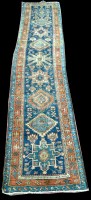 Lot 976 - A Heriz runner, the geometric medallions on...