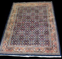 Lot 991 - A Kerman carpet, with flowerhead motifs to...