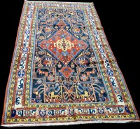 Lot 1023 - A Persian rug, of geometric design with...