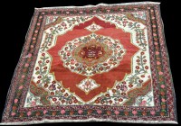 Lot 1033 - A Caucasian rug, the central rosette on red...