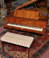 Lot 1057 - A walnut cased baby grand piano, by...