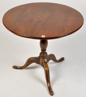 Lot 1100 - An early 19th Century oak tip-up-top table,...